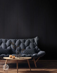 Black acoustic slat wall panels in a modern living room with a stylish sofa, enhancing interior design and sound quality.