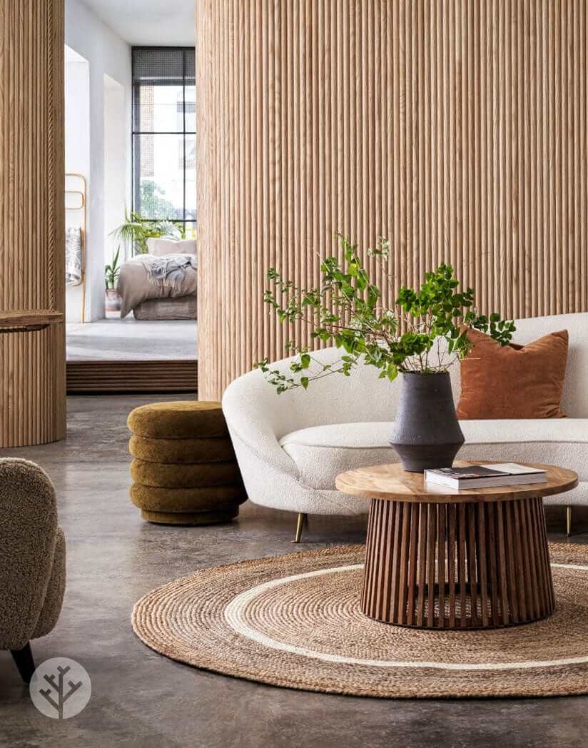 Luxury living room with Oak Ridge Flexible Tambour Wood Panels on walls, featuring modern furniture and earthy decor elements.