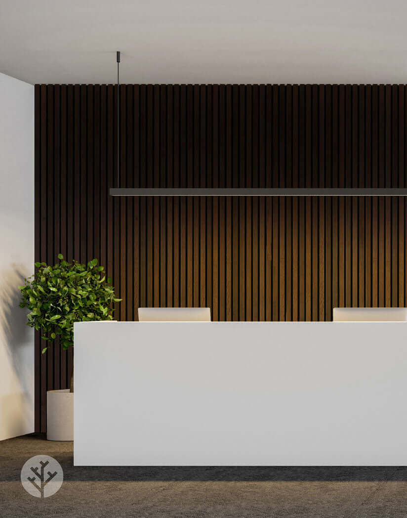 Smoked Oak Acoustic Slat Wood Wall Panels in modern interior design with a white reception desk and green plant accent.
