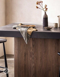 Walnut Mini-Ridge flexible tambour wood panels on a modern kitchen island with decor accents.
