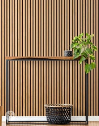 Natural Oak Acoustic Slat Wood Wall Panels enhancing modern interior with lush green plant and stylish console.