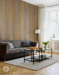 Modern living room with natural oak acoustic slat wood wall panelling, grey sofa, and a black coffee table for elegant interior design.