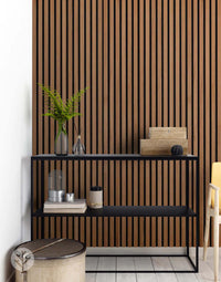 Natural Walnut Acoustic Slat Wood Wall Panels in modern interior with black shelf, showcasing elegant design and sound improvement benefits.