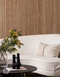 Luxury living room with Oak Mini-Ridge Flexible Tambour Wood Panels adding warmth and elegance to the wall behind a modern sofa and decor.