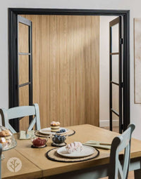Elegant interior with Oak Mini-Ridge Flexible Tambour Wood Panels on wall, adding warmth and luxury to dining space.