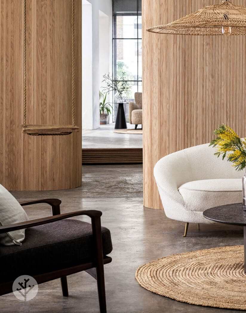 Luxurious interior featuring Oak Mini-Ridge Flexible Tambour Wood Panels on walls, accenting modern living space with warmth and elegance.