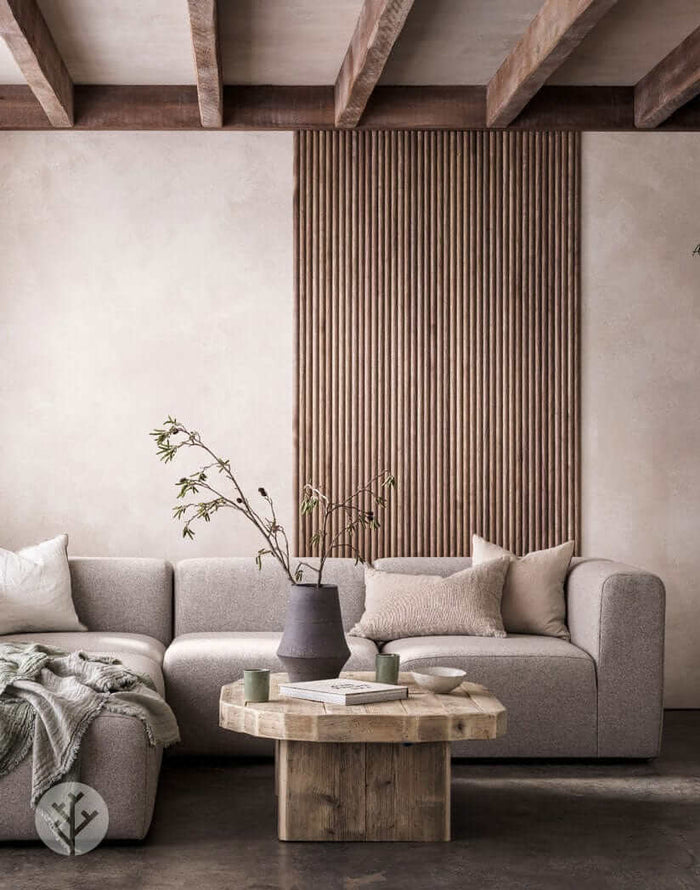 Luxury interior with Walnut Ridge Flexible Tambour Wood Panels on wall, featuring modern sofa and wooden coffee table.
