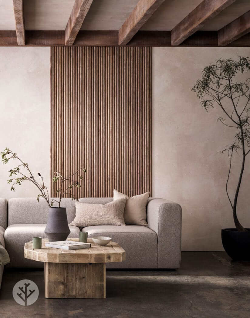 Living room with Walnut Ridge Flexible Tambour Wood Panel accent wall, featuring a modern sofa and rustic coffee table. Luxury wall panels decor.