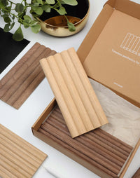 Flexible tambour wood panels sample box showcasing oak and walnut designs, ideal for architects and designers.