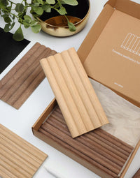 Flexible tambour wood panels sample box showcasing oak and walnut designs, ideal for architects and designers.