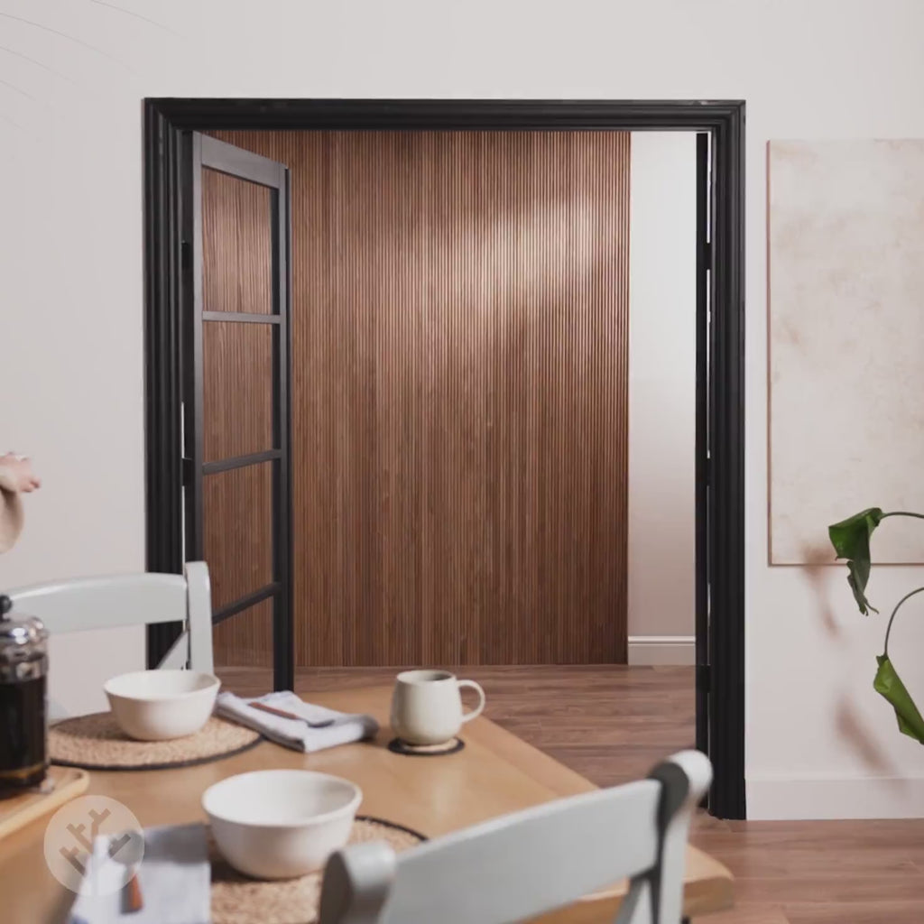 Elegant dining area showcasing walnut tambour wood panels, enhancing the space with flexible and fluted design.