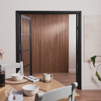 Elegant dining area showcasing walnut tambour wood panels, enhancing the space with flexible and fluted design.